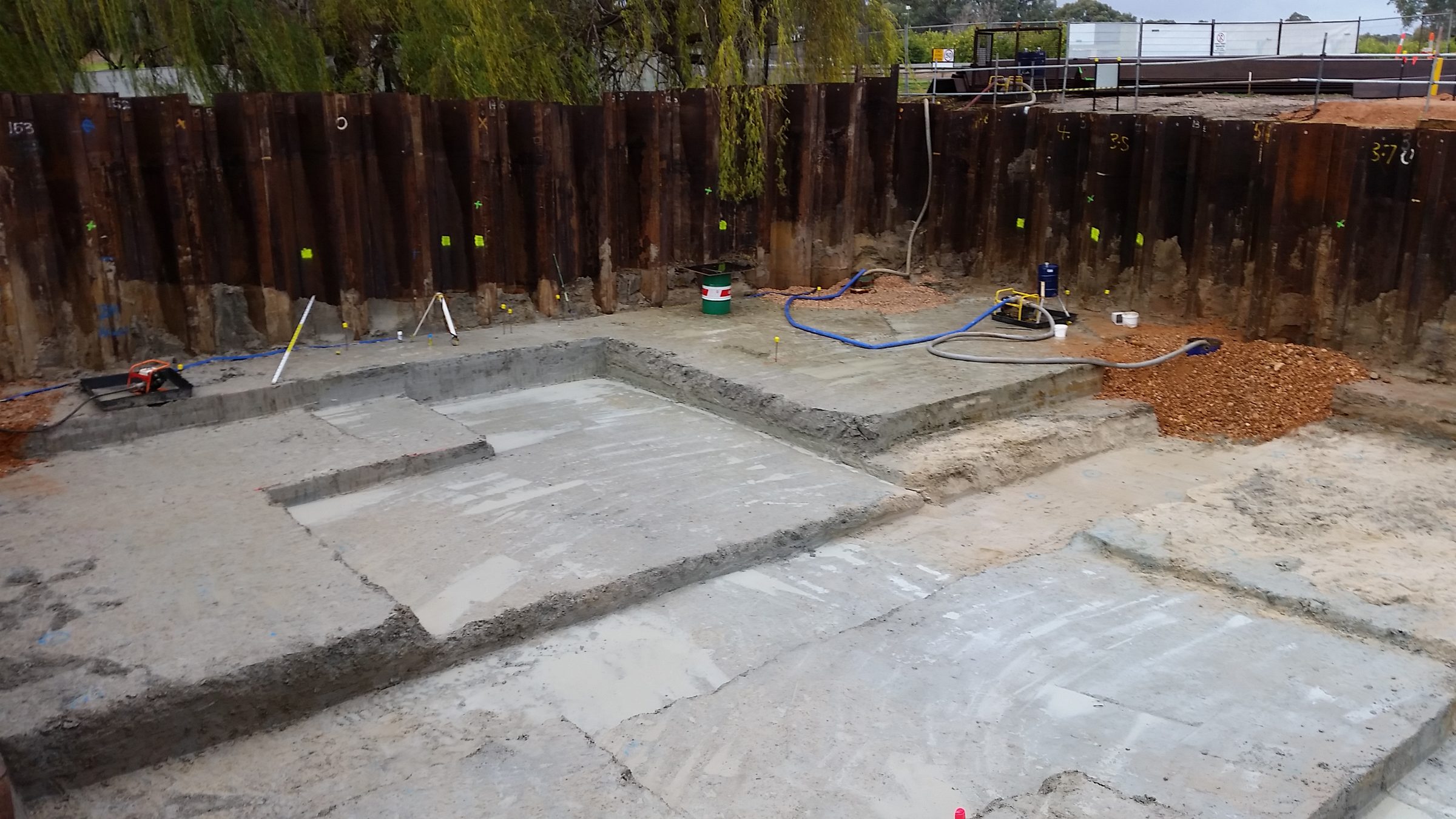 Sheet-piled excavation with concrete works underway